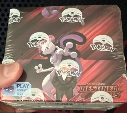 Sealed Pokémon TCG Scarlet & Violet Destined Rivals booster box artwork featuring Mewtwo and Giovanni in plastic shrink wrap